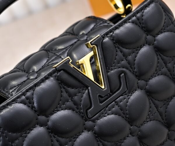 M23998 black. This Monogram embroidered floral design emerges in the elegant quilting, measuring 22 x 12 x 8 cm.