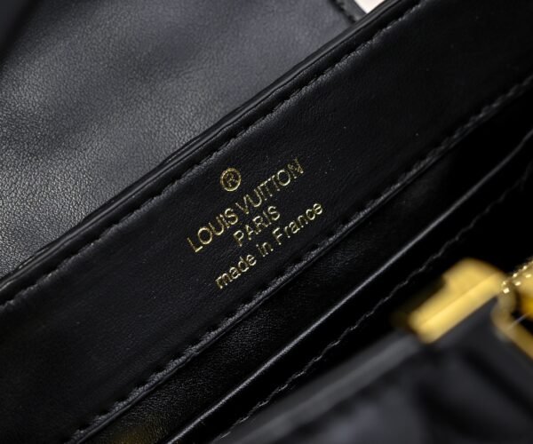 M23998 black. This Monogram embroidered floral design emerges in the elegant quilting, measuring 22 x 12 x 8 cm.