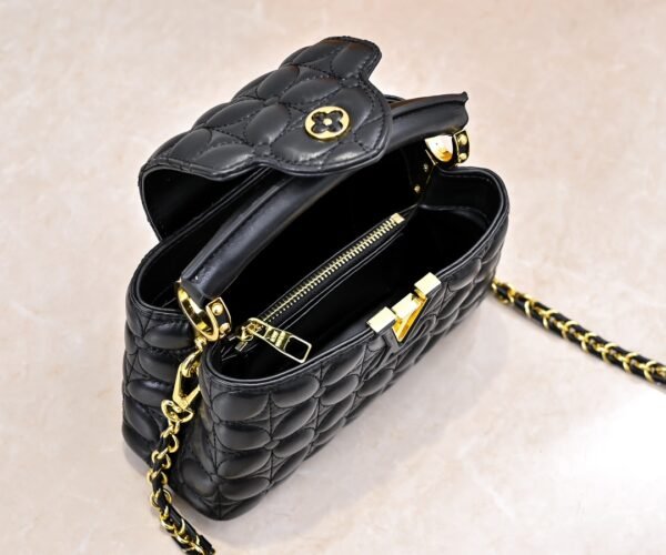 M23998 black. This Monogram embroidered floral design emerges in the elegant quilting, measuring 22 x 12 x 8 cm.