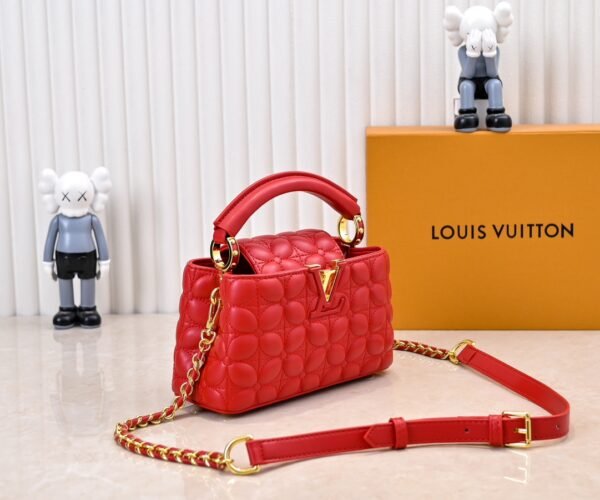 M23998 Red. This Monogram embroidered floral design emerges in the elegant quilting, adding to the Louis Vuitton store's decoration style for the Capucines mini handbag - 22 x 12 x 8 cm