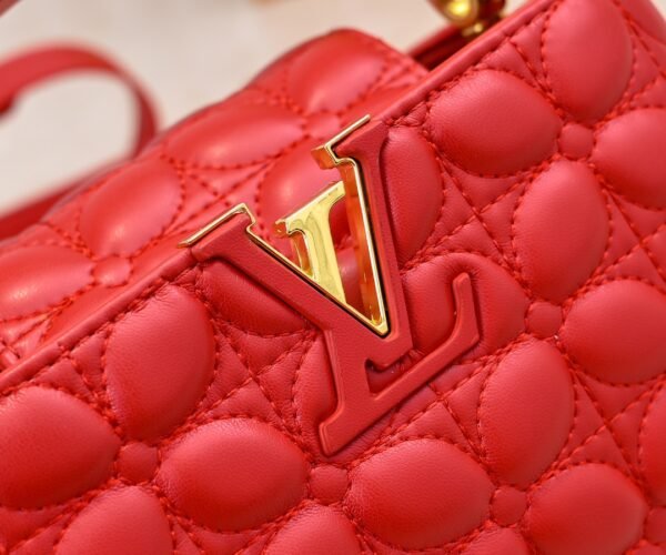 M23998 Red. This Monogram embroidered floral design emerges in the elegant quilting, adding to the Louis Vuitton store's decoration style for the Capucines mini handbag - 22 x 12 x 8 cm