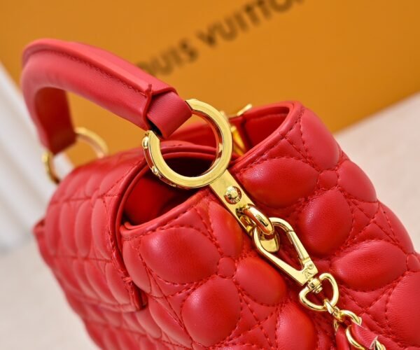 M23998 Red. This Monogram embroidered floral design emerges in the elegant quilting, adding to the Louis Vuitton store's decoration style for the Capucines mini handbag - 22 x 12 x 8 cm