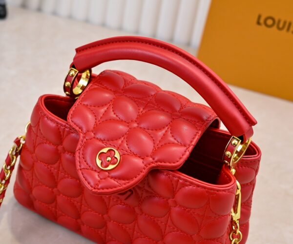 M23998 Red. This Monogram embroidered floral design emerges in the elegant quilting, adding to the Louis Vuitton store's decoration style for the Capucines mini handbag - 22 x 12 x 8 cm