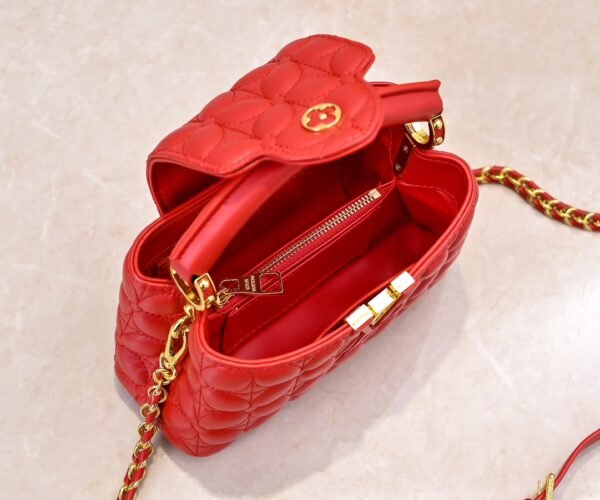 M23998 Red. This Monogram embroidered floral design emerges in the elegant quilting, adding to the Louis Vuitton store's decoration style for the Capucines mini handbag - 22 x 12 x 8 cm