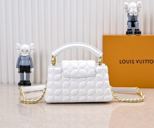 M23998 White. This Monogram embroidered floral design appears in the elegant quilting. Capucines mini handbag. Dimensions: 22 x 12 x 8 cm.