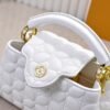 M23998 White. This Monogram embroidered floral design appears in the elegant quilting. Capucines mini handbag. Dimensions: 22 x 12 x 8 cm.