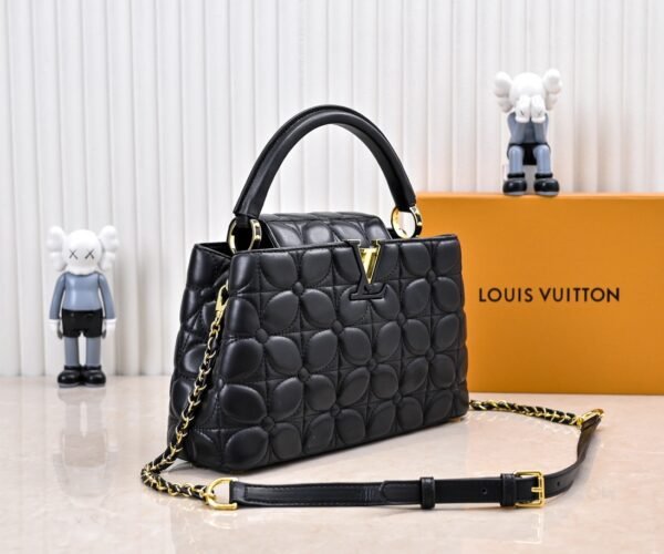 M23999 black. This Monogram embroidered floral design emerges in the elegant quilting, adding to the Louis Vuitton store's decoration style for the Capucines BB handbag. 33 x 19 x 9 cm