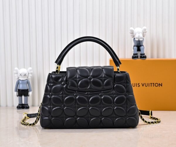 M23999 black. This Monogram embroidered floral design emerges in the elegant quilting, adding to the Louis Vuitton store's decoration style for the Capucines BB handbag. 33 x 19 x 9 cm