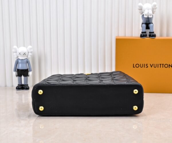 M23999 black. This Monogram embroidered floral design emerges in the elegant quilting, adding to the Louis Vuitton store's decoration style for the Capucines BB handbag. 33 x 19 x 9 cm