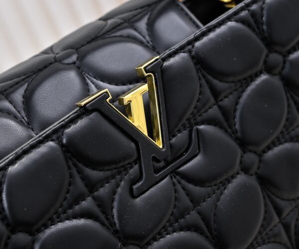 M23999 black. This Monogram embroidered floral design emerges in the elegant quilting, adding to the Louis Vuitton store's decoration style for the Capucines BB handbag. 33 x 19 x 9 cm