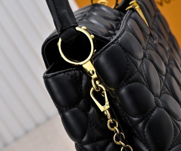 M23999 black. This Monogram embroidered floral design emerges in the elegant quilting, adding to the Louis Vuitton store's decoration style for the Capucines BB handbag. 33 x 19 x 9 cm