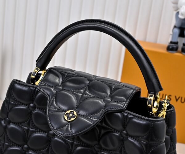 M23999 black. This Monogram embroidered floral design emerges in the elegant quilting, adding to the Louis Vuitton store's decoration style for the Capucines BB handbag. 33 x 19 x 9 cm