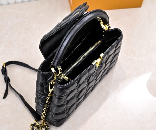 M23999 black. This Monogram embroidered floral design emerges in the elegant quilting, adding to the Louis Vuitton store's decoration style for the Capucines BB handbag. 33 x 19 x 9 cm