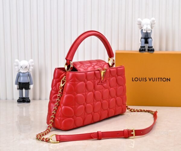 M23999 red. This Monogram embroidered floral design emerges in the elegant quilting, adding to the Louis Vuitton store's decoration style for the Capucines BB handbag. 33 x 19 x 9 cm