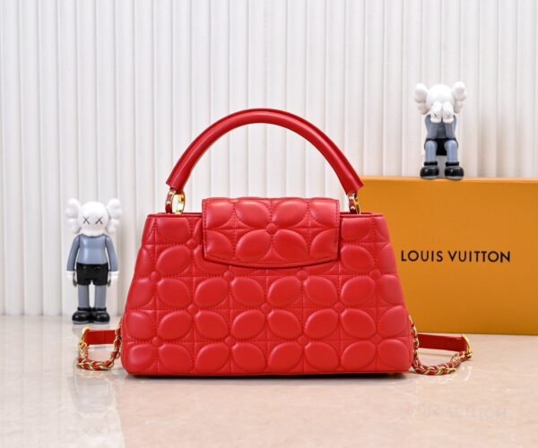 M23999 red. This Monogram embroidered floral design emerges in the elegant quilting, adding to the Louis Vuitton store's decoration style for the Capucines BB handbag. 33 x 19 x 9 cm