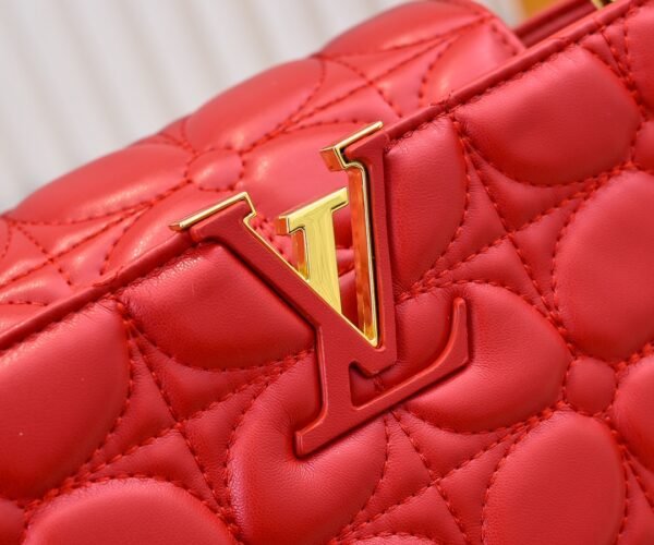 M23999 red. This Monogram embroidered floral design emerges in the elegant quilting, adding to the Louis Vuitton store's decoration style for the Capucines BB handbag. 33 x 19 x 9 cm
