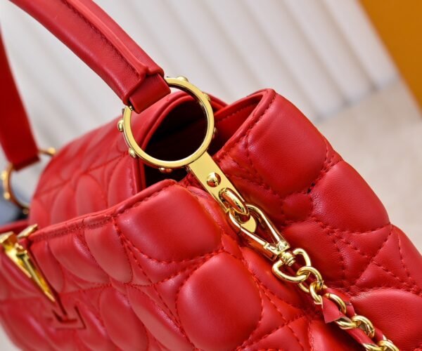 M23999 red. This Monogram embroidered floral design emerges in the elegant quilting, adding to the Louis Vuitton store's decoration style for the Capucines BB handbag. 33 x 19 x 9 cm