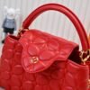 M23999 red. This Monogram embroidered floral design emerges in the elegant quilting, adding to the Louis Vuitton store's decoration style for the Capucines BB handbag. 33 x 19 x 9 cm