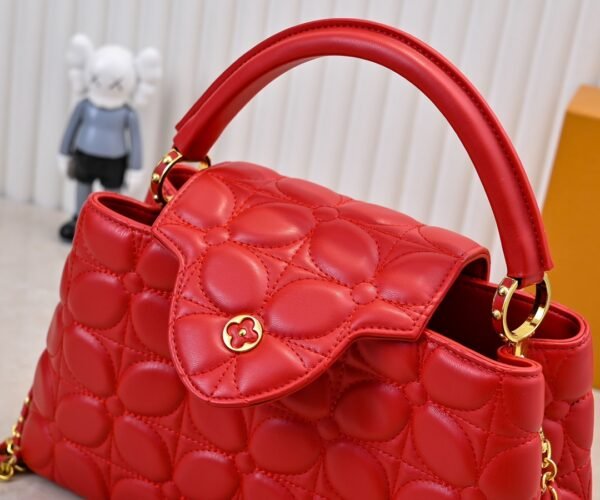 M23999 red. This Monogram embroidered floral design emerges in the elegant quilting, adding to the Louis Vuitton store's decoration style for the Capucines BB handbag. 33 x 19 x 9 cm