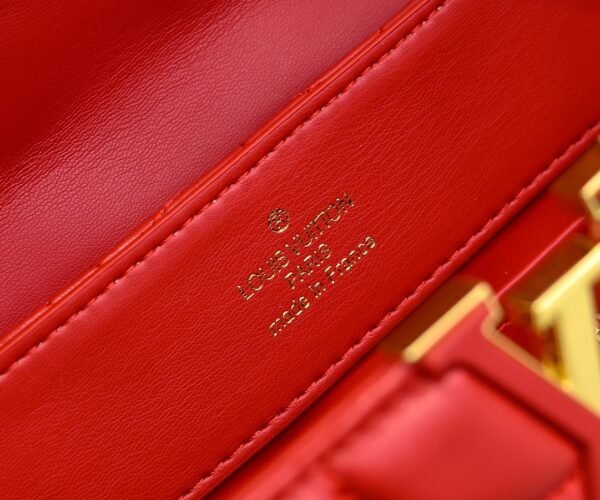 M23999 red. This Monogram embroidered floral design emerges in the elegant quilting, adding to the Louis Vuitton store's decoration style for the Capucines BB handbag. 33 x 19 x 9 cm