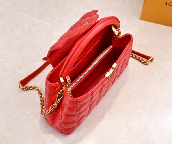 M23999 red. This Monogram embroidered floral design emerges in the elegant quilting, adding to the Louis Vuitton store's decoration style for the Capucines BB handbag. 33 x 19 x 9 cm