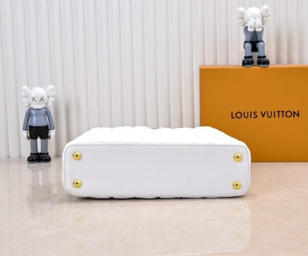 M23999 white. This Monogram embroidered floral design emerges in the elegant quilting, adding to the Louis Vuitton store's decoration style for the Capucines BB handbag. 33 x 19 x 9 cm