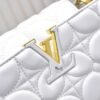 M23999 white. This Monogram embroidered floral design emerges in the elegant quilting, adding to the Louis Vuitton store's decoration style for the Capucines BB handbag. 33 x 19 x 9 cm