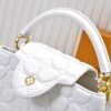 M23999 white. This Monogram embroidered floral design emerges in the elegant quilting, adding to the Louis Vuitton store's decoration style for the Capucines BB handbag. 33 x 19 x 9 cm